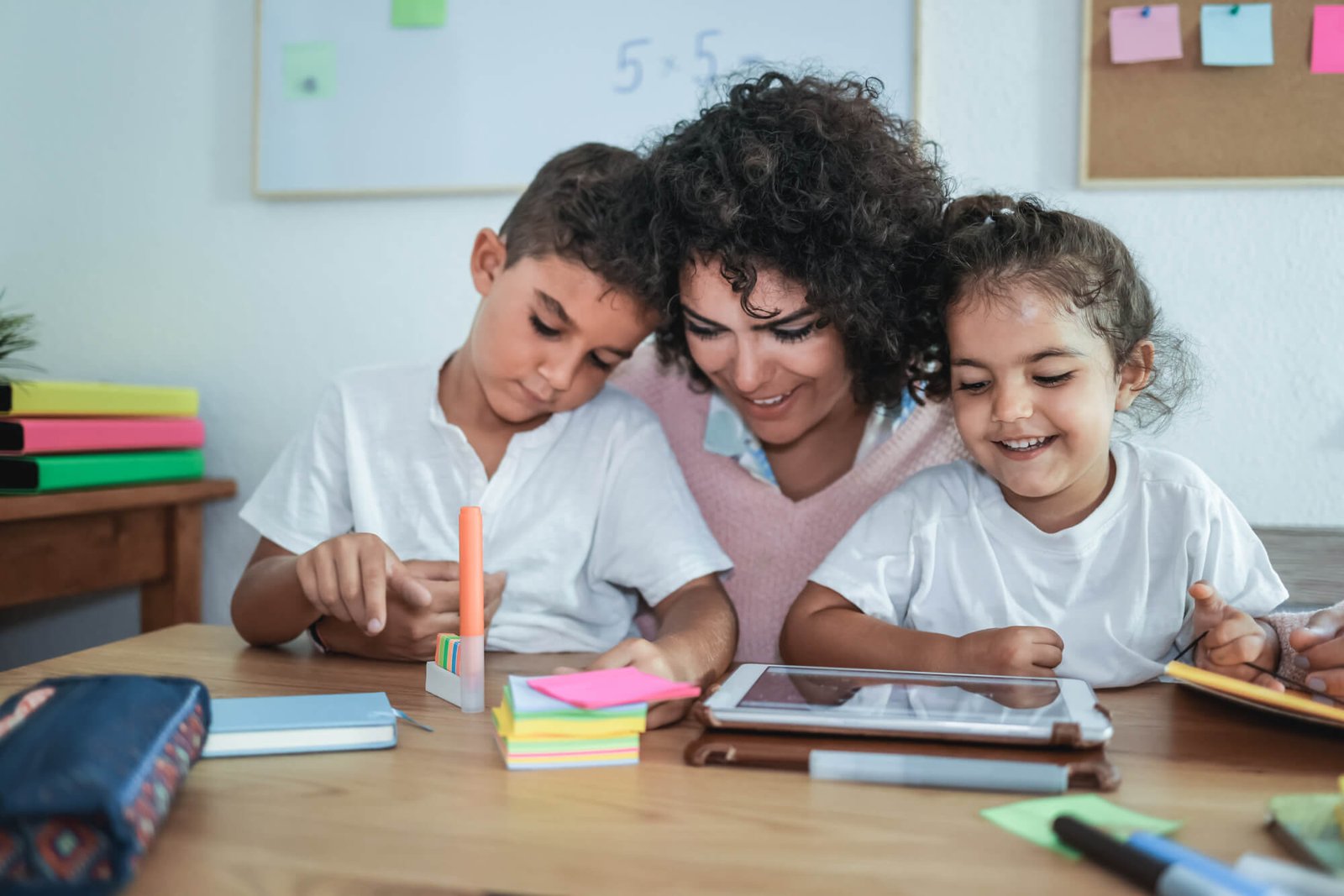 teacher-using-tablet-with-children-in-kindergarten-school-focus-on-girl-face.jpg